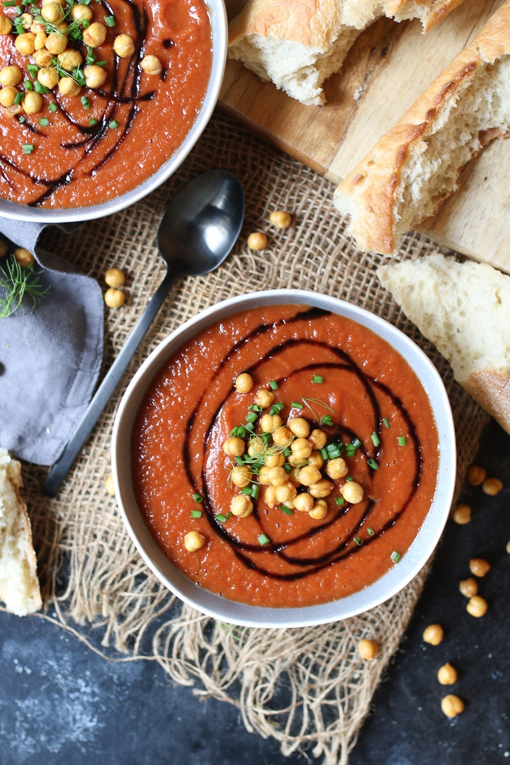 birds eye view of vegan tomato soup topped with chickpea croutons in a white bowl