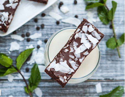 Holiday chocolate bar sitting on a glass of milk. 