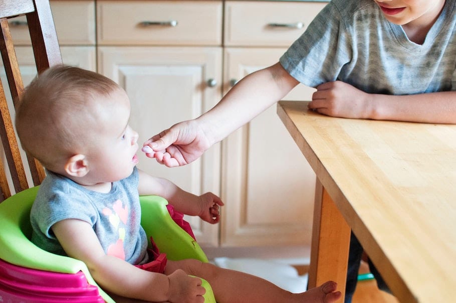 Parent starting solids for baby.