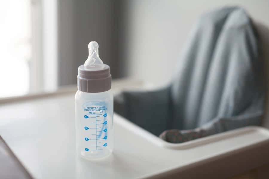 Baby bottle in a high chair for starting solids.