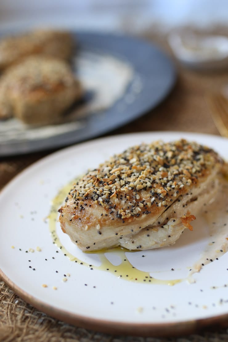 White meat everything bagel spiced chicken breast served on a white plate.