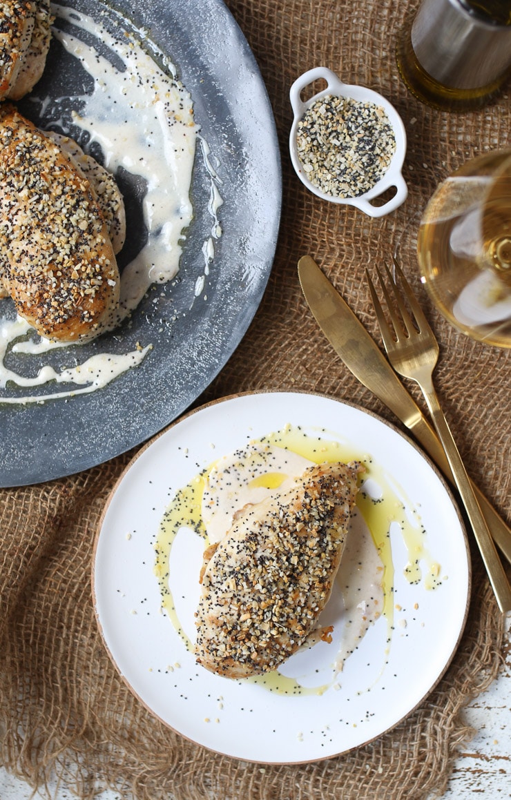 Birds eye view of chicken breast served on a white plate topped with seasoning. 