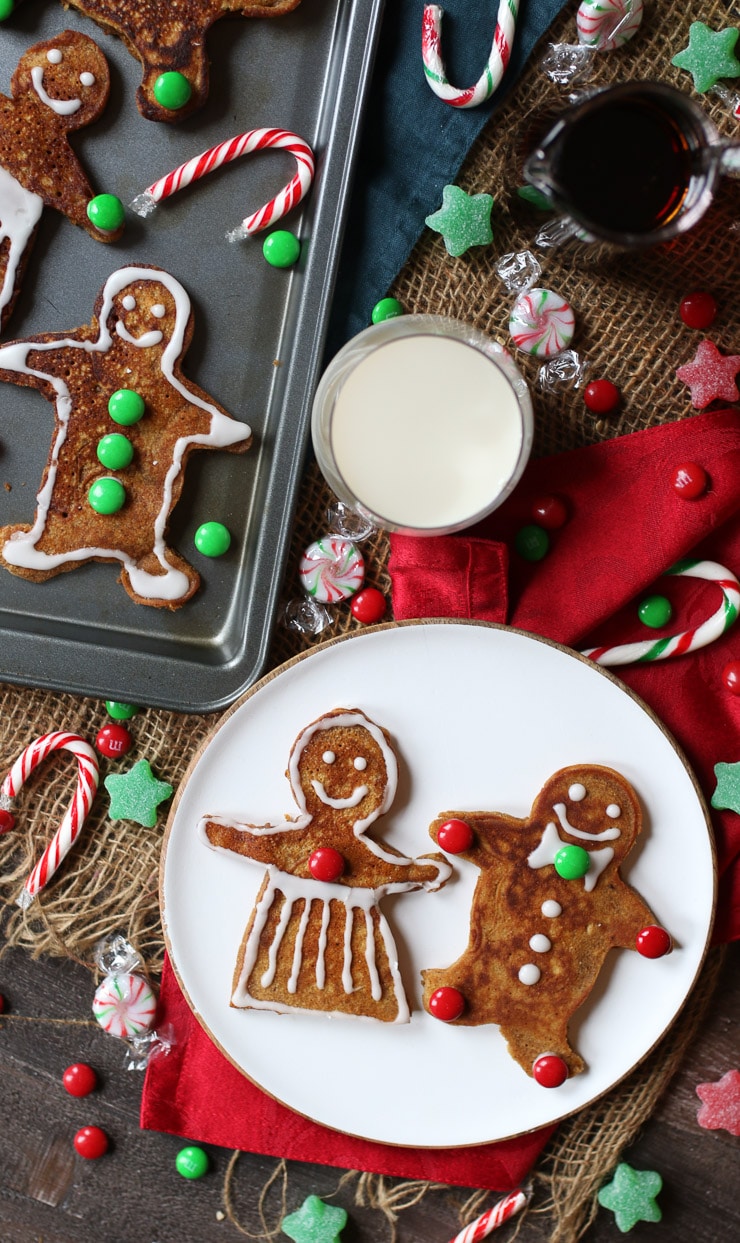 birds eye view of gingerbread holiday pancakes next to a glass of milk.