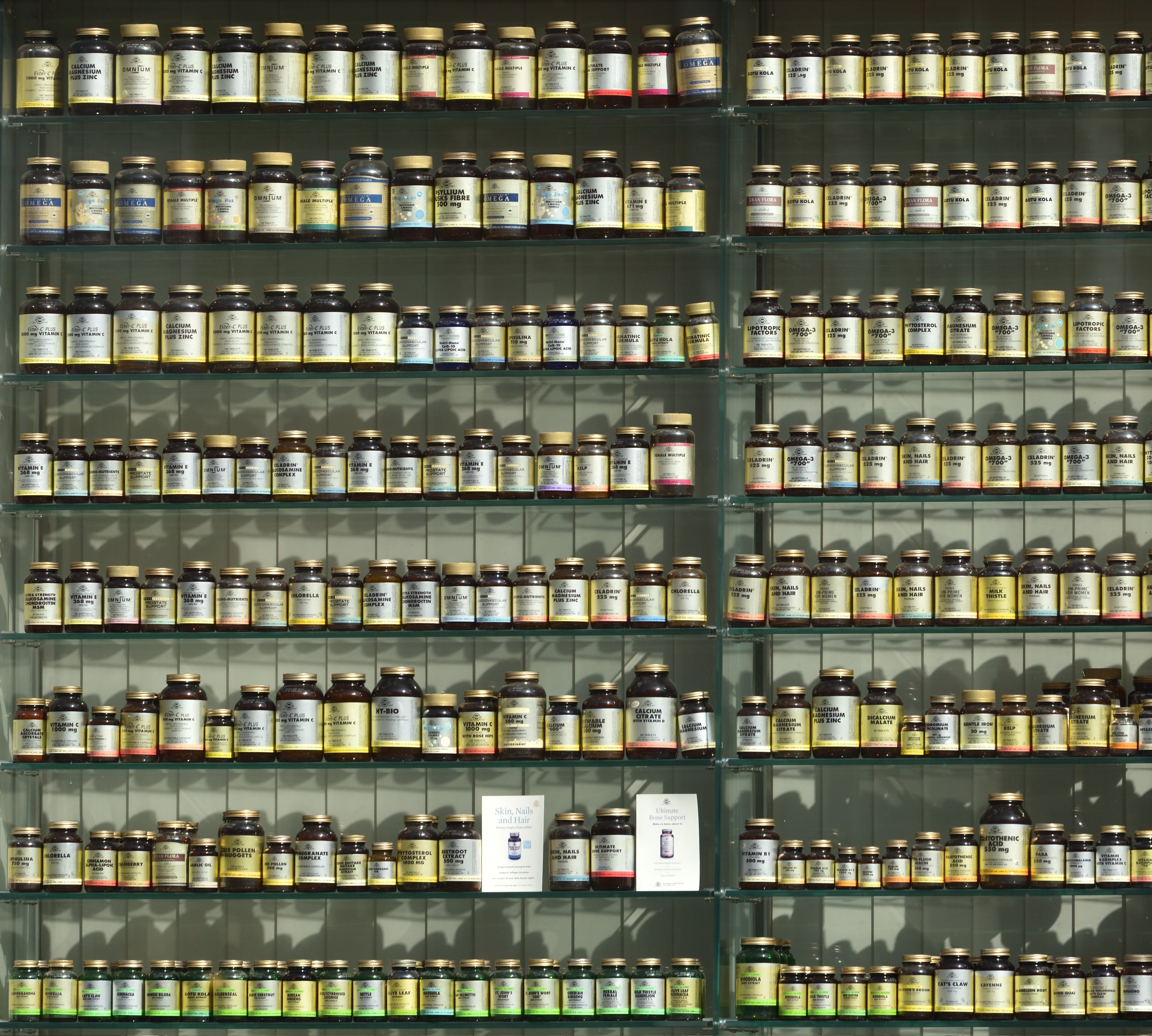 Multiple rows of natural health supplements on shelves.