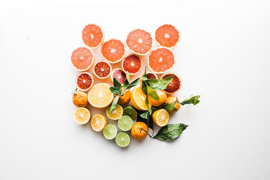 Birds eye view of fruits and vegetables on a white surface.