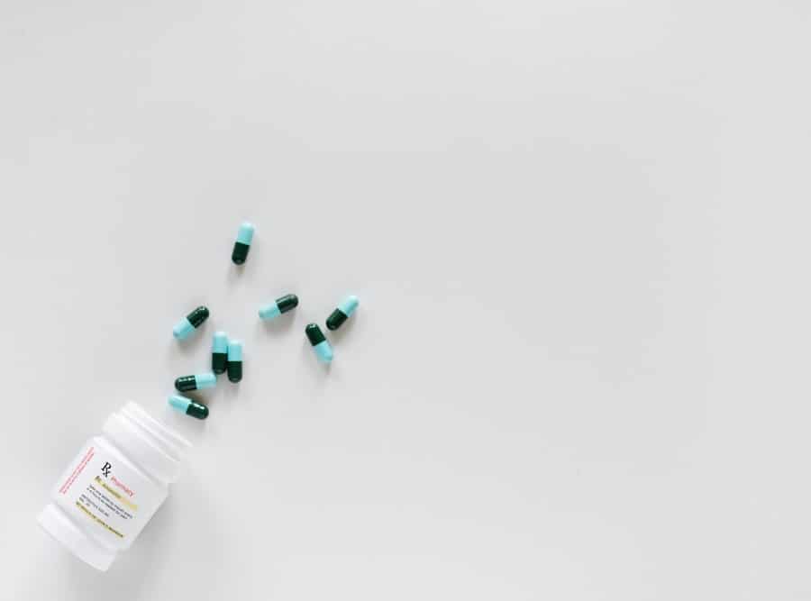 blue pills for food allergies on a white surface