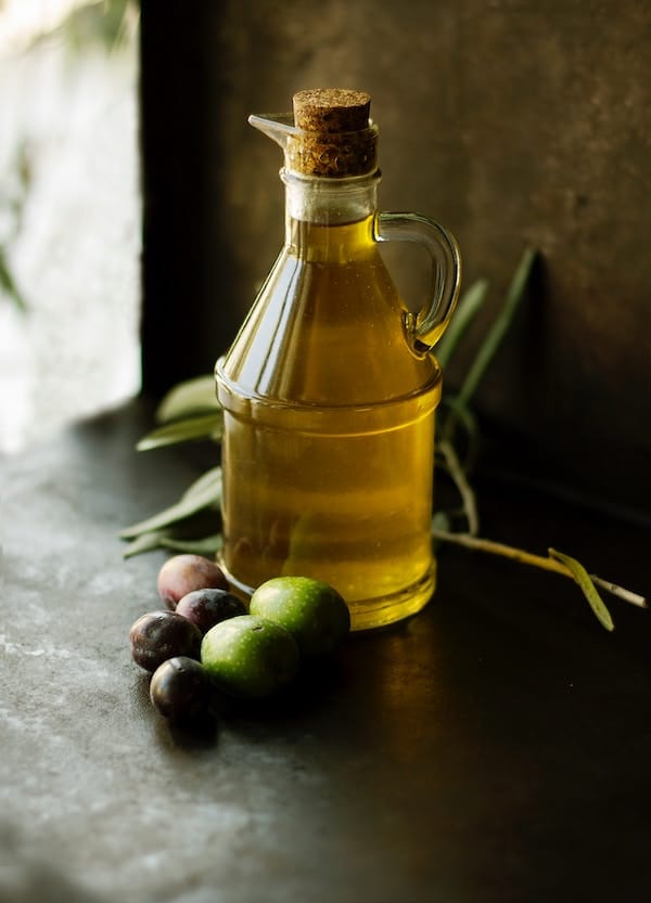 Jug of olive oil consumed as a postpartum hair loss remedy.