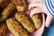 Baby grabbing a salmon sweet potato fritter.