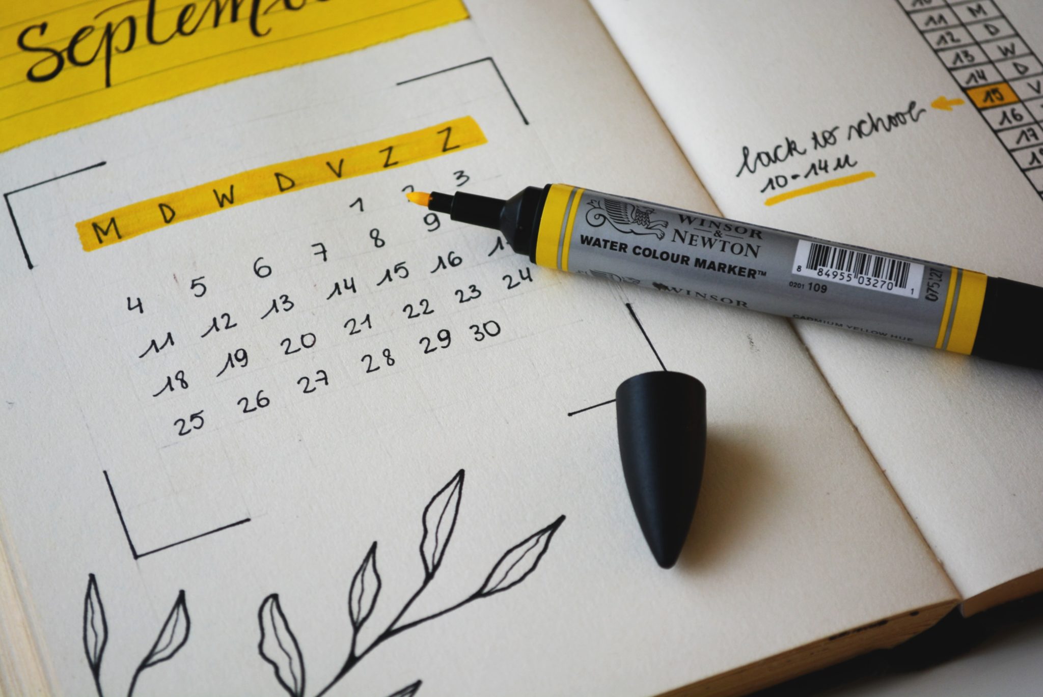 close up image of a calendar with a pen marking the days of a menstrual cycle