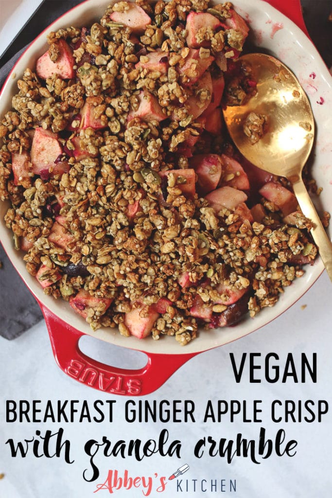 Close up of granola fruit crisp with apples and figs and a bronze serving spoon sitting in the dish.
