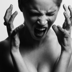 A woman screaming in black and white.