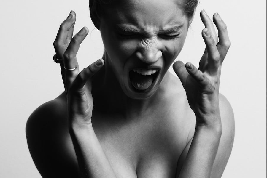 A woman screaming in black and white referring to experiencing anxiety while pregnant. 