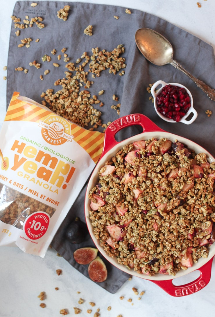 Birds eye view of ginger apple crisp next to a bag of Manitoba Hemp Foods Harvest granola. 