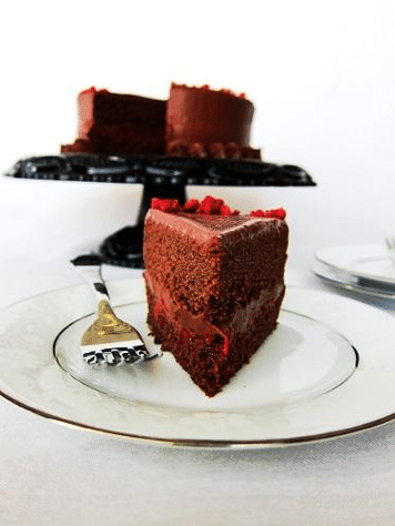 slice of vegan dark chocolate and red wine cake on a white plate