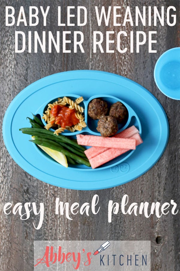 pinterest image of Baby led weaning dinner containing meatballs, pasta with tomato sauce, green beans and watermelon slices with text overlay