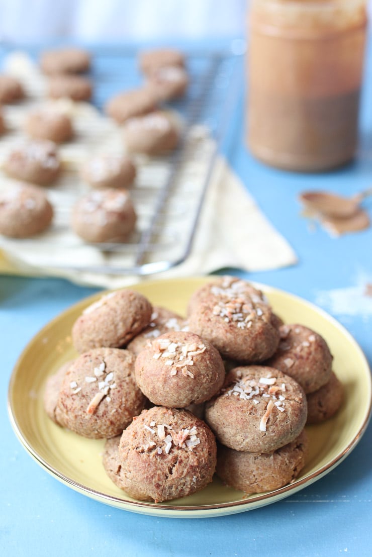 Chickpea peanut butter baby biscuits on a yellow plate.