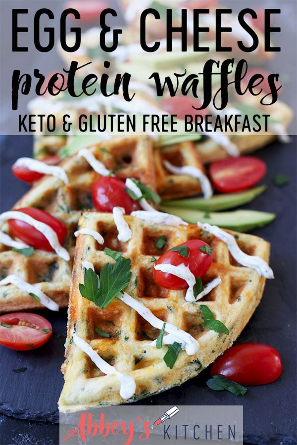Egg and cheese savoury protein waffles topped with sliced avocados, cherry tomatoes, creamy drizzle and parsley.