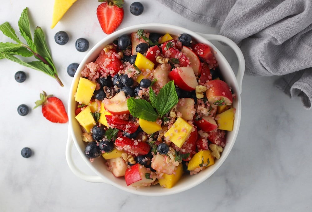 Quinoa fruit salad in a white serving dish from family meal plan.