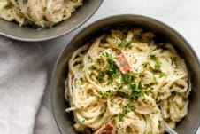 Two grey bowls filled with pasta carbonara.