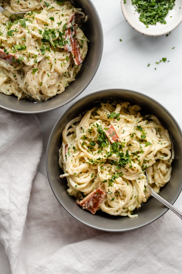 Two grey bowls filled with pasta carbonara from family meal plan.