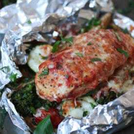 Baked chicken parmesan foil pack dinner with vegetables.