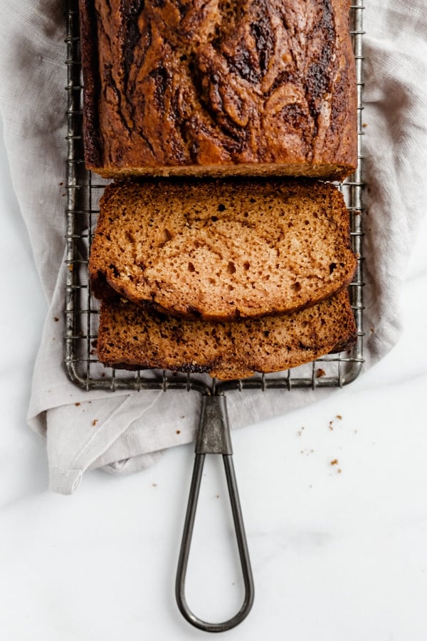 A banana bread loaf on a wire rack from family meal plan.