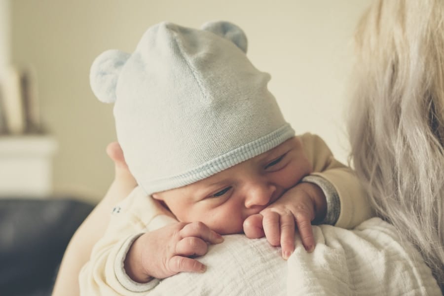 Newborn baby on mom's shoulder.