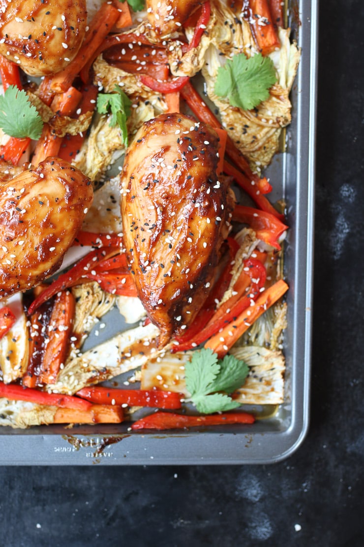 Baked sweet and sour chicken sheet pan dinner with cabbage and peppers.