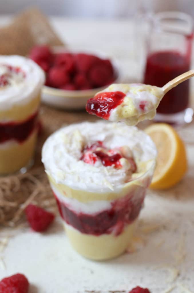 Spoonful of vegan lemon mousse parfait with raspberry chia jam.