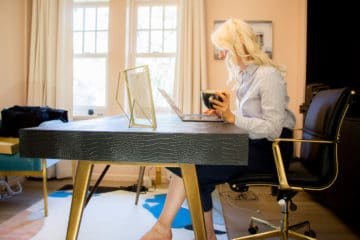 Blonde woman working at her desk.