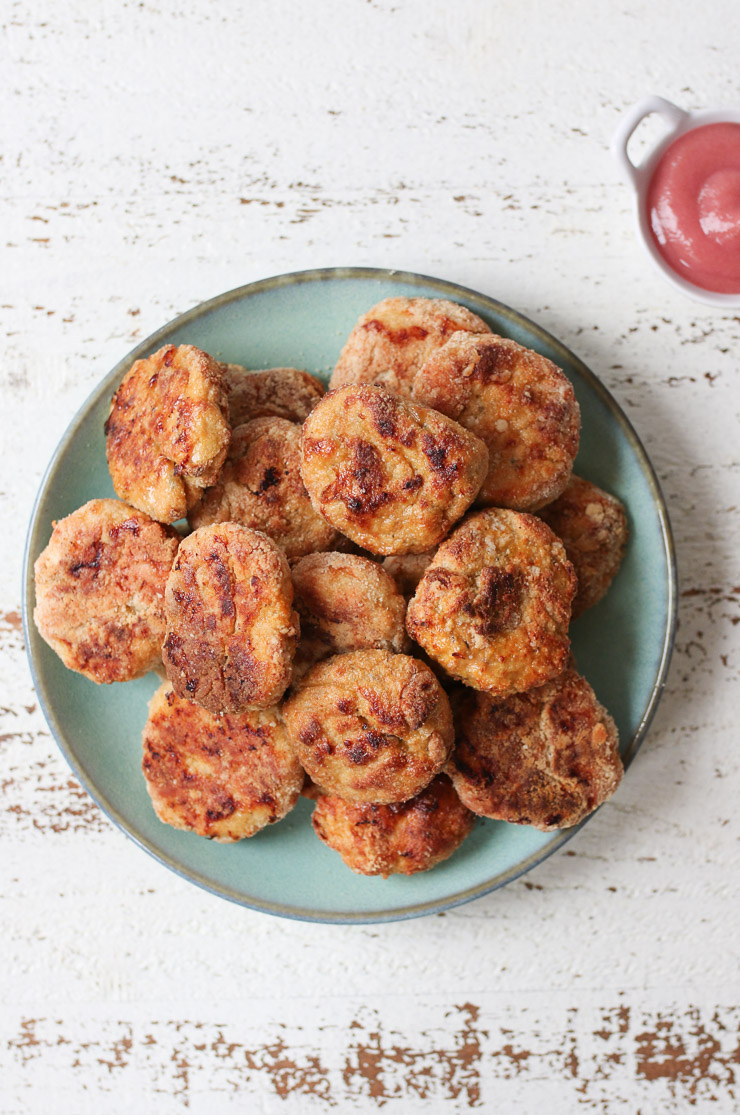 Healthy chicken nuggets on a turquoise plate.