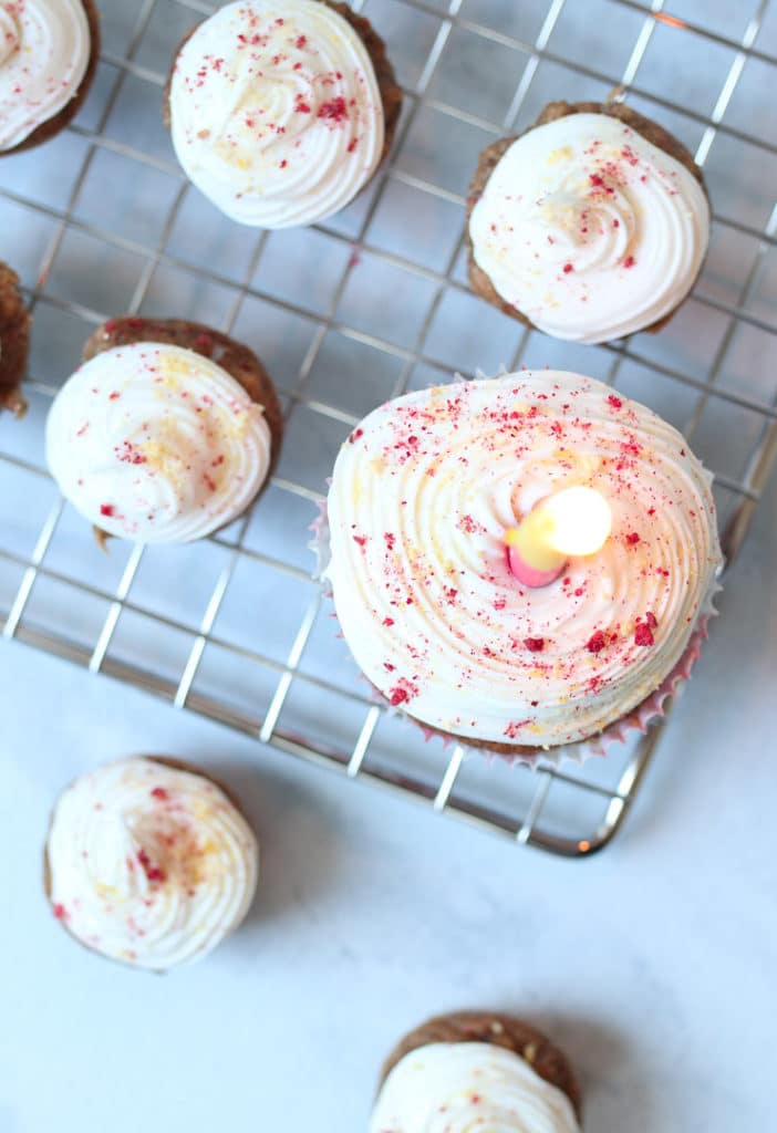 Mini cupcake with one lit candle in the midle.