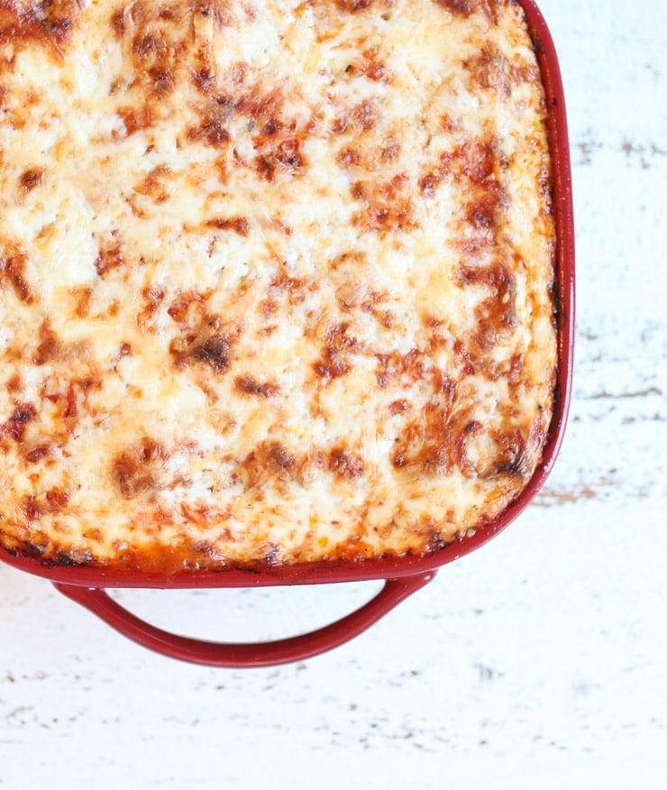 Cheesy vegetarian matzo lasagna in a red casserole dish for Passover.