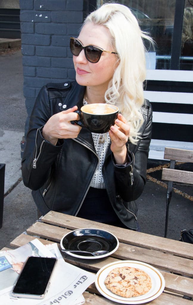 Women enjoying a latte on a patio.