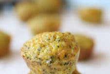 Two mini broccoli and cheese egg muffins piled on top of each other.