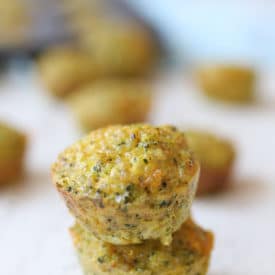 Two mini broccoli and cheese egg muffins piled on top of each other.