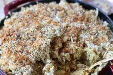 Everything Bagel Vegan Mac and Cheese in a red casserole dish.