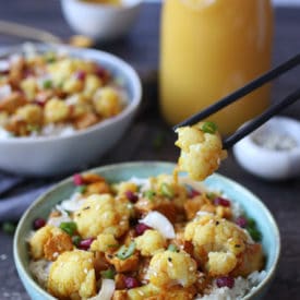 Bowl of orange chicken and cauliflower instant pot recipe with chopsticks.