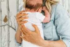Blonde woman holding her baby.
