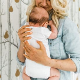 Blonde woman holding her baby.