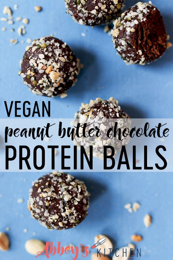 Peanut butter chocolate protein balls scattered on a blue background.