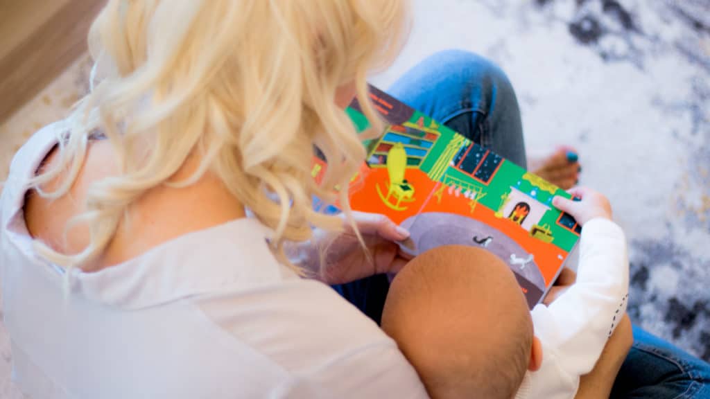 Women reading to her baby.