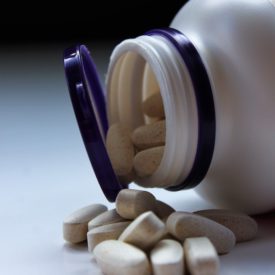 A pill bottle containing iron supplements.