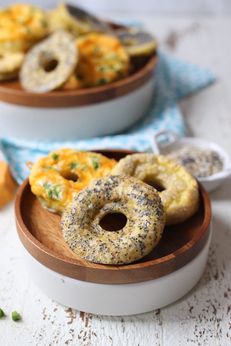 Keto everything bagel, jalepeno cheddar and poppyseed bagels on a wooden plate.