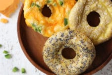 Keto everything bagel, jalepeno cheddar and poppyseed bagels on a wooden plate.