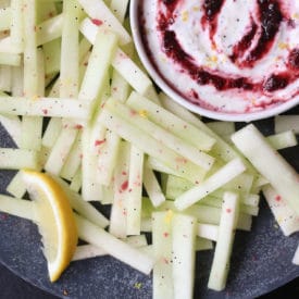 Honeydew melon fries next to poppyseed cherry dip.