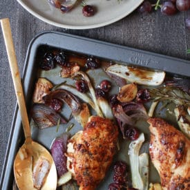 Rosemary chicken on a sheet pan with roasted grapes and veggies.