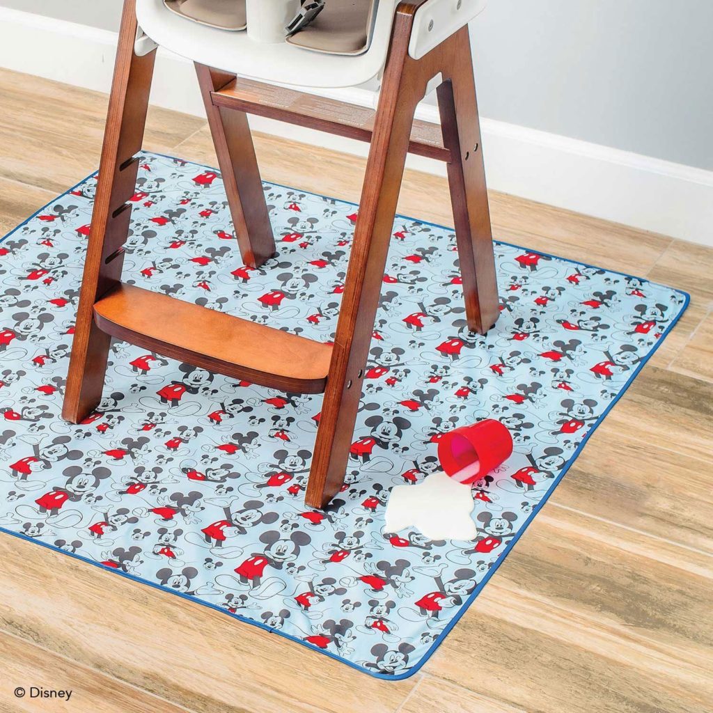 Splat mat underneath a baby high chair.