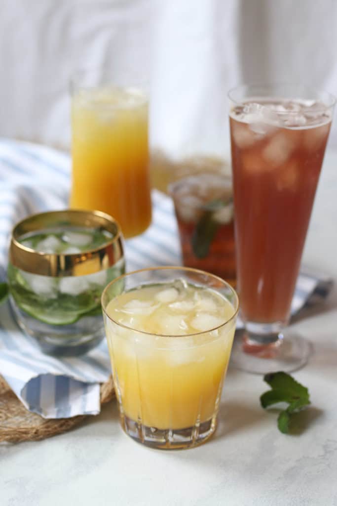 Various low sugar hydrating drinks in clear glasses