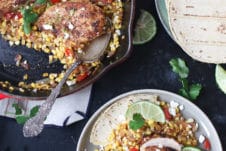 Mexican chicken and corn in a pan next to a serving on a plate.